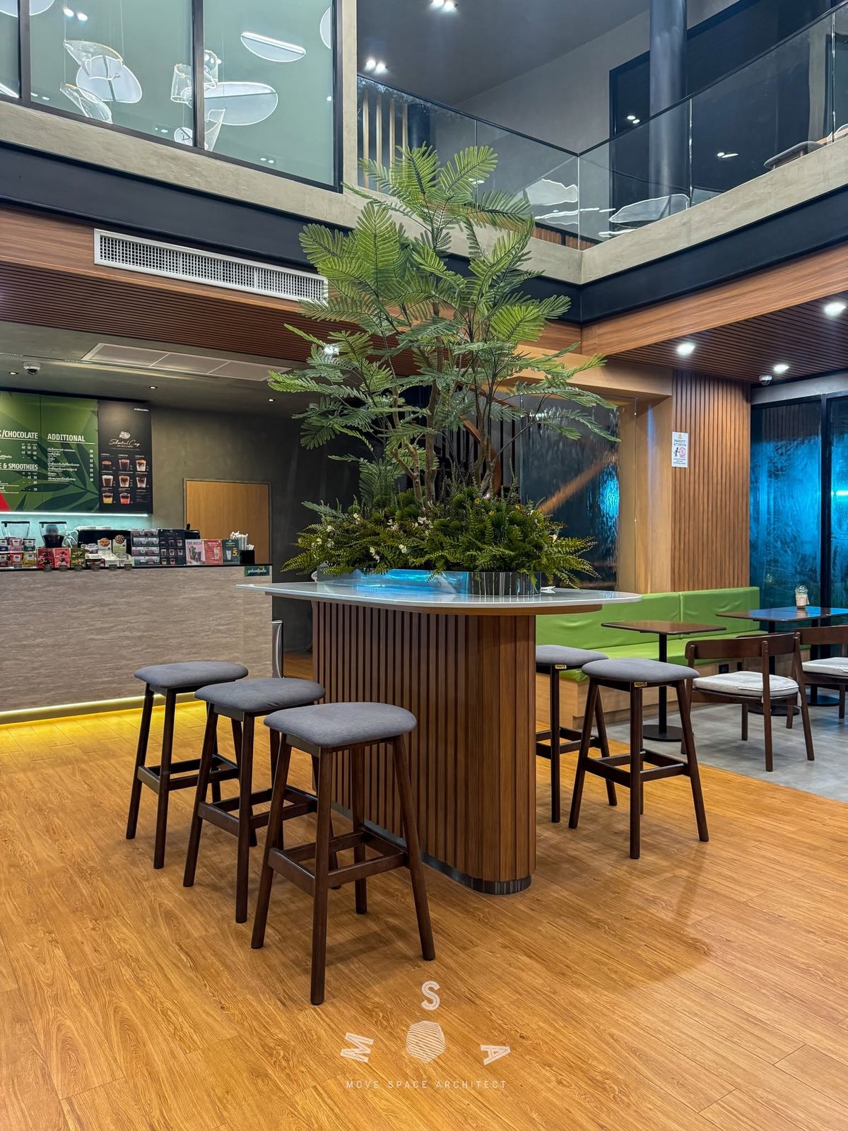 Café Amazon · Ao Noi — Planter bar and high stools (photograph)